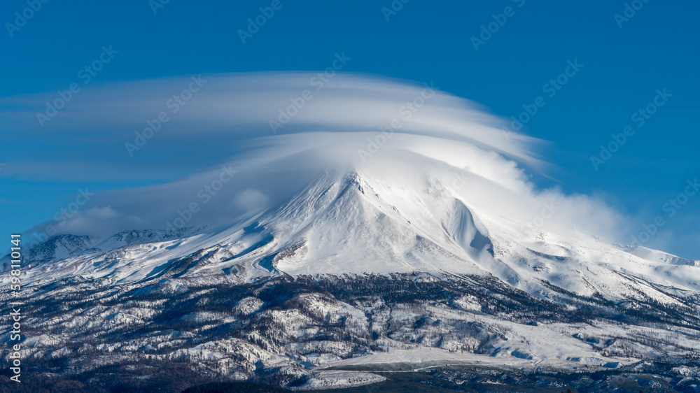 Lenticular clouds over Mount Shasta and Shastina's northwest facing view. Cascade Mountain Range. Siskiyou County, California. Shasta-Trinity National Forest.