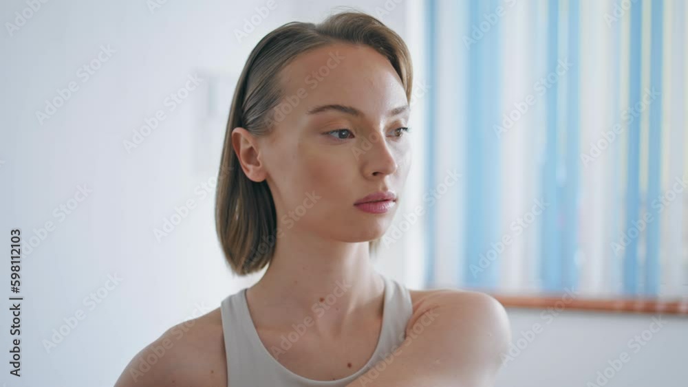 Focused girl warming body white interior closeup. Athlete model stretching hands Generative AI Focused girl warming body white interior closeup. Athlete model stretching hands Generative AI