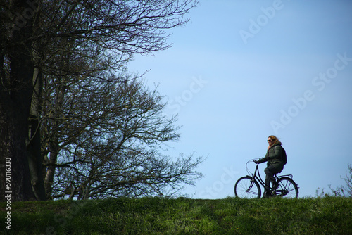 woman with bicycle outdoors in the park