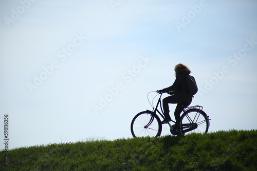 woman with bicycle outdoors in the park