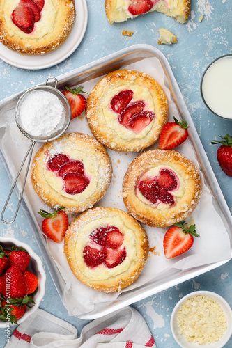 Brioche buns with strawberries, ricotta cream and vanilla streusel. Summer berry pastry. Top view