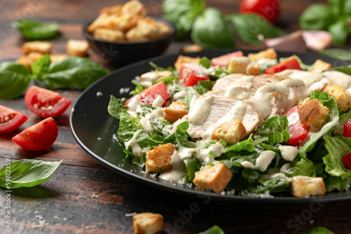 A delicious chicken caesar salad with parmesan cheese, tomatoes, croutons and dr Fototapet