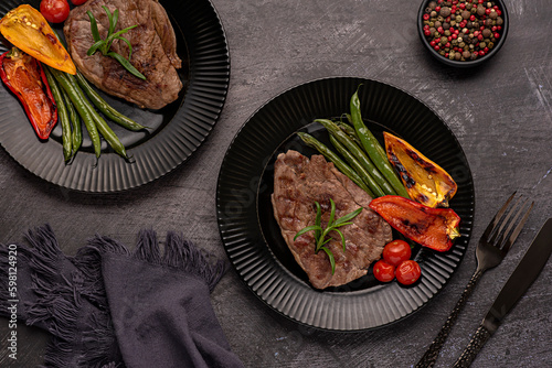 Food photography of roasted lamb steak, grilled, meat, fillet, green beans, paprika, cherry tomatoes
