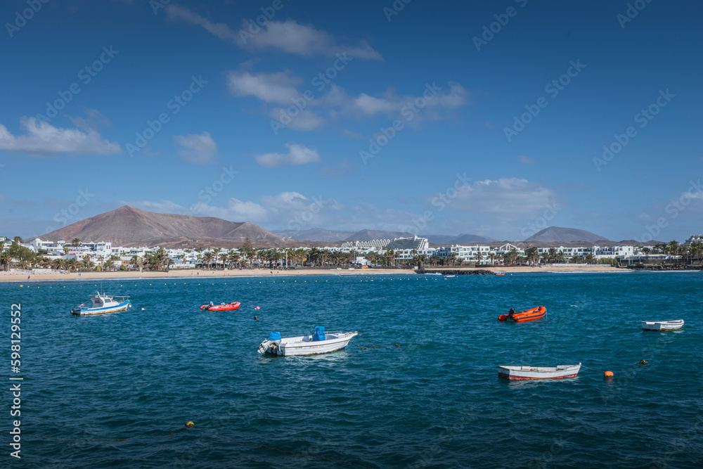 Fishing boats in turquoise sea near Costa Teguise, Lanzarote, Canary Islands