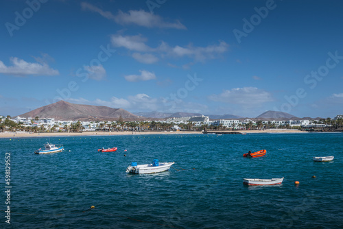 Fishing boats in turquoise sea near Costa Teguise, Lanzarote, Canary Islands © Anastasija