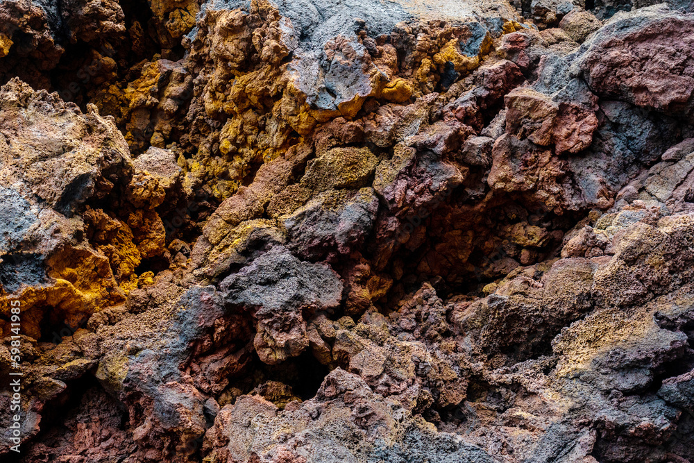 Detail of the red and yellow colors in the volcanic stones in Charco Manso on the island of El Hierro. Canary Islands