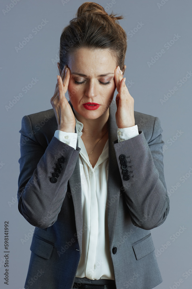 stressed young business woman against gray background stressed young business woman against gray background
