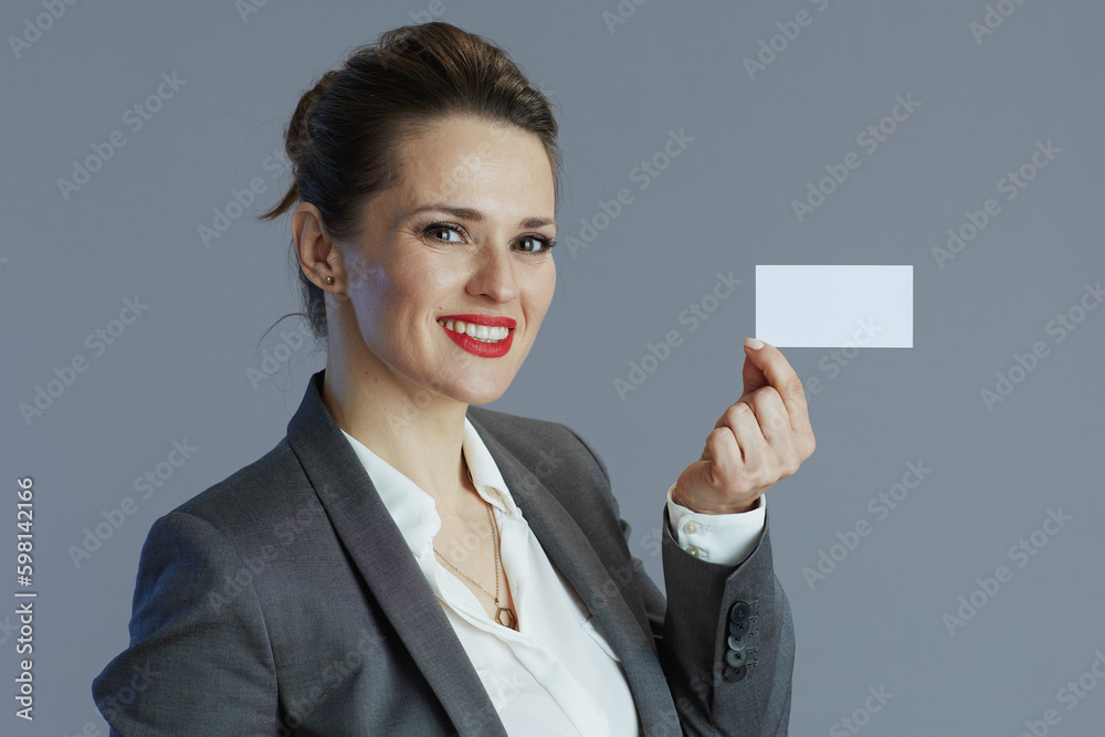 smiling stylish business owner woman isolated on gray smiling stylish business owner woman isolated on gray