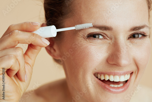 smiling woman with brow brush