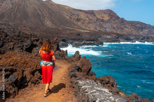 A mother with her son walking on the volcanic trail in the village of Tamaduste on the island of El Hierro, Canary Islands, Spain photo