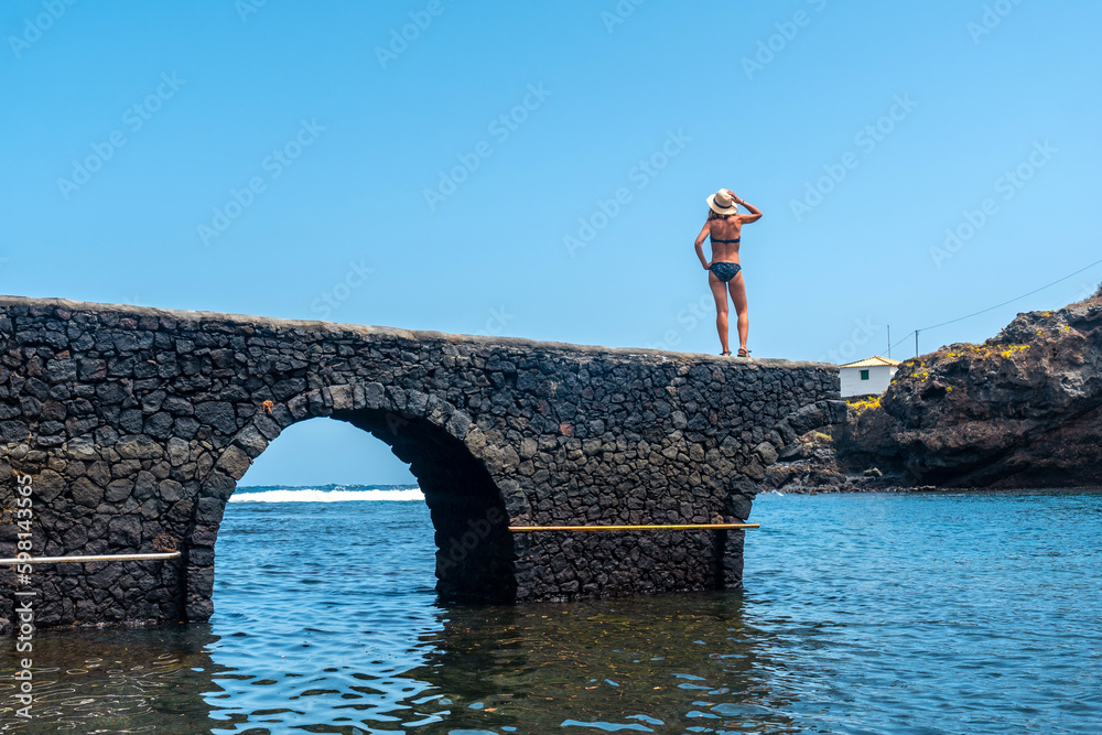 Fototapeta premium Portrait of a young woman on vacation in the seaside tourist village Tamaduste on the island of El Hierro, Canary Islands, Spain