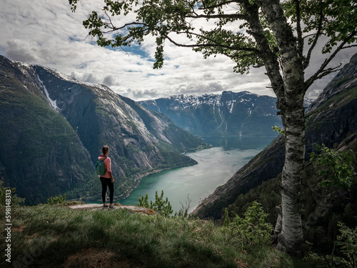 Canvas Print Girl standing on top of Eidfjord in Norway, looking over the fjord and mountains
