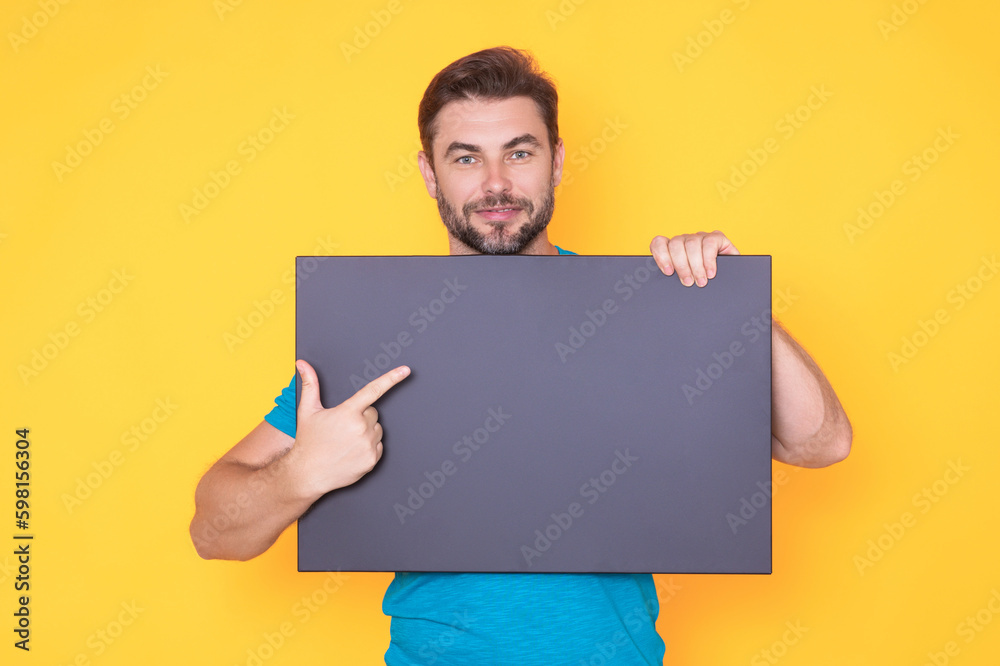 Middle aged man showing promo. Pointing finger on blank board concept. Blank signboard with copyspace. Advertisement concept. Ad board with copy space, blank mockup. Blank signboard, placard. Middle aged man showing promo. Pointing finger on blank board concept. Blank signboard with copyspace. Advertisement concept. Ad board with copy space, blank mockup. Blank signboard, placard.