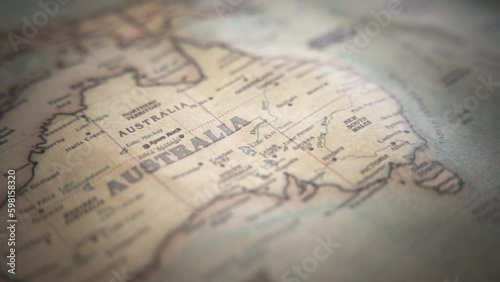 Australia on a vintage political world map. Slow motion, tracking arc shot. 