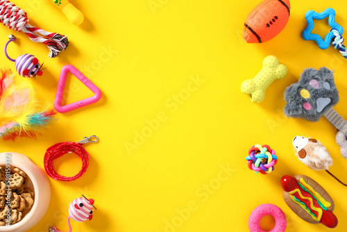 Frame of pet care and training accessories on yellow background. Flat lay, top view, copy space