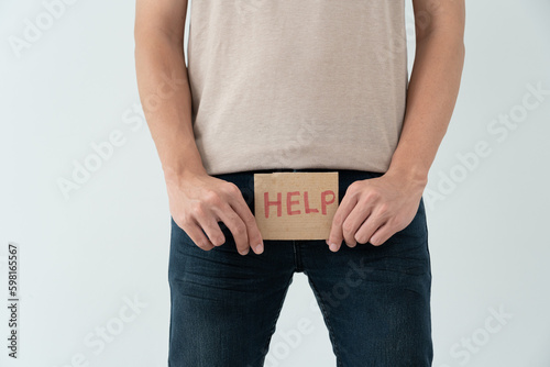 Foto Man hold hand in front of private parts feeling discomfort from disease and inflammation
