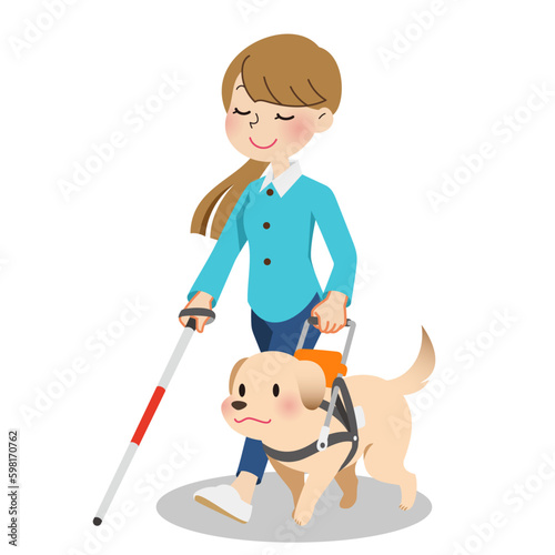 杖を突きながら盲導犬と歩く女性 photo