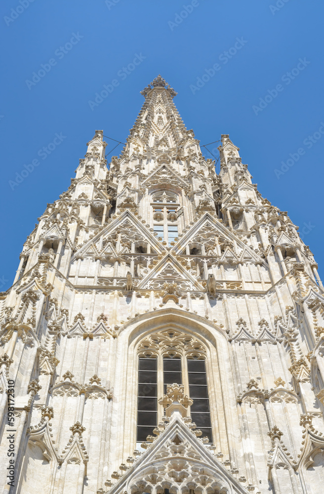 A low view of part of St. Stephen's Cathedral in Vienna against a blue sky