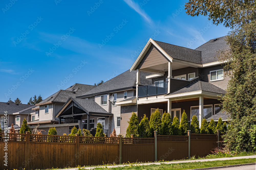 Perfect neighborhood. Houses in suburb at Spring in the north America. Real Estate Exterior Front Houses on a sunny day Perfect neighborhood. Houses in suburb at Spring in the north America. Real Estate Exterior Front Houses on a sunny day