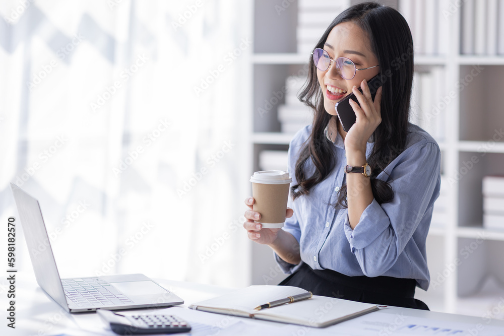 Cheerful business Asian woman freelancer making telephone call share good news about project working in office workplace, business finance concept.
Cheerful business Asian woman freelancer making telephone call share good news about project working in office workplace, business finance concept.