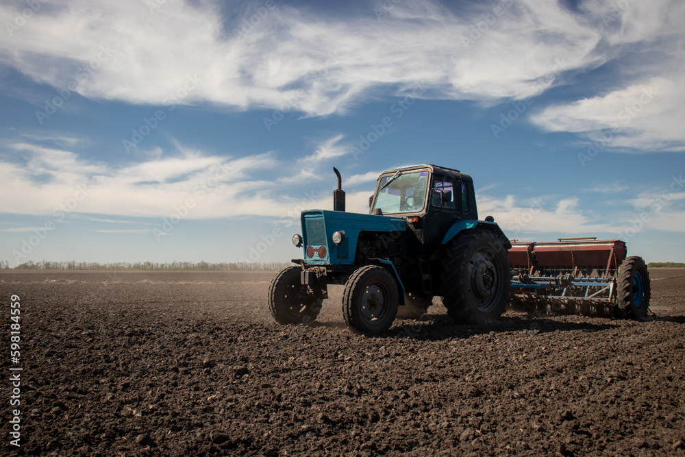 Old tractor planting in field Old tractor planting in field