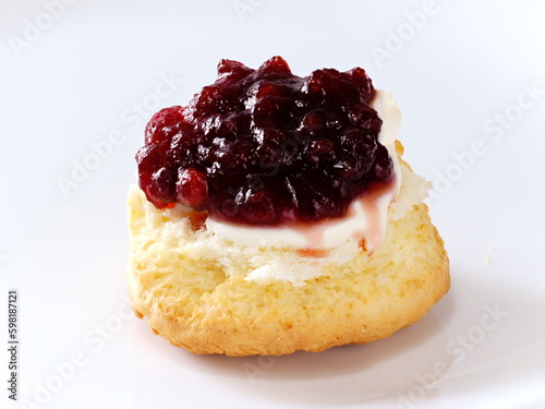 Tokyo, Japan - May 1, 2023: Closeup of a scone and clotted cream and jam on white background
 photo
