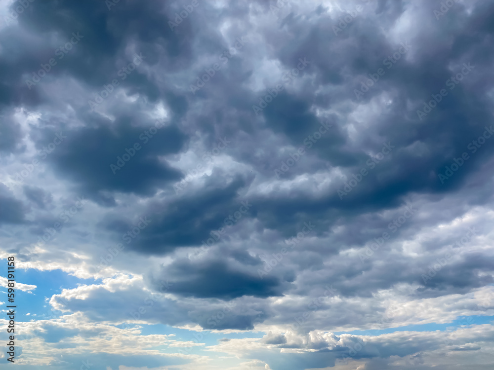 The sky at sunset is a beautiful sight with a stunning array of colors blending seamlessly into each other. Grey, blue, pink and purple hues create a breathtaking spectacle.