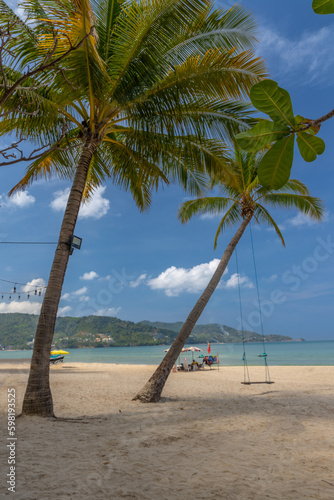 Patong Beach Phuket Thailand nice white sandy beach clear blue and turquoise waters and lovely blue skies with Palms tree