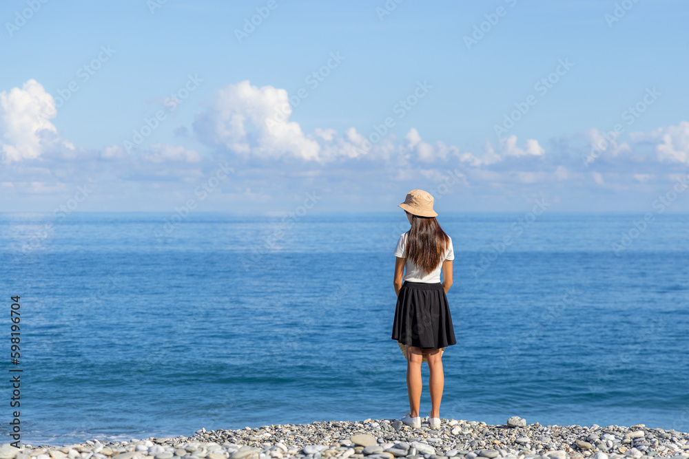 Woman stand in front of the sea beach