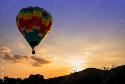 Hot air balloons flying over the valley on sunset in summer time