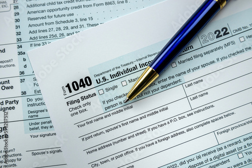 cloeup of 1040 US federal income tax return form with pen