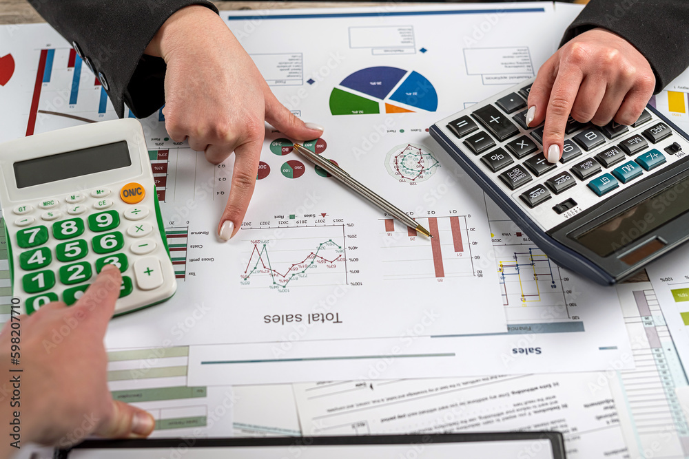 Manager working with finance charts graph and doing annual analytic research document at office Manager working with finance charts graph and doing annual analytic research document at office