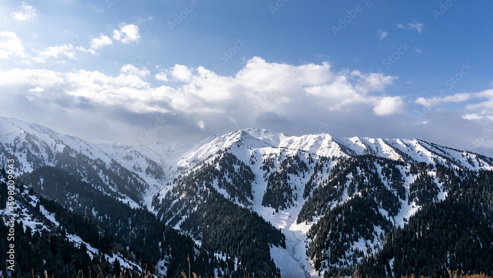 snowy mountain peaks in the clouds. cloudy weather in the mountains. snow cliffs. beautiful clouds