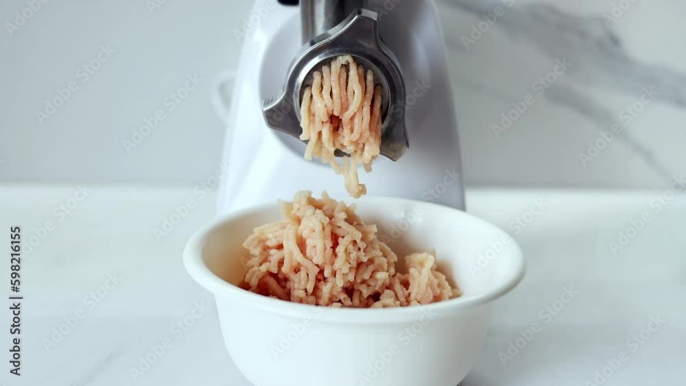 Cooking minced meat in an electric meat grinder from. The process of grinding meat in an electric meat grinder close-up. Kitchen appliances. Cooking minced meat in an electric meat grinder from. The process of grinding meat in an electric meat grinder close-up. Kitchen appliances.