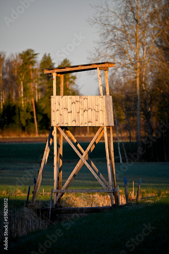 hunting tower standing in agriculture field early morning