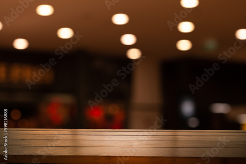 wooden table and bokeh cafe background. product display template