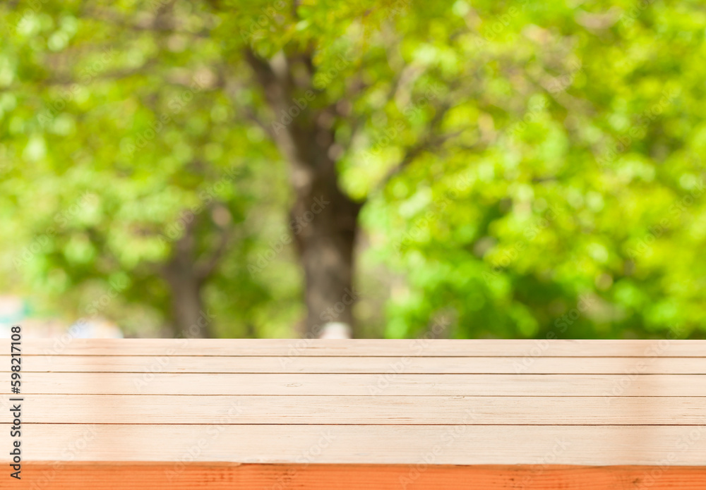 light wooden table on blurred nature bokeh background