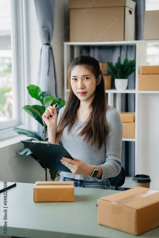 Small business entrepreneur SME freelance woman working at home office, boxs ,tablet and laptop online, marketing, packaging, delivery, e-commerce concept. Small business entrepreneur SME freelance woman working at home office, boxs ,tablet and laptop online, marketing, packaging, delivery, e-commerce concept.