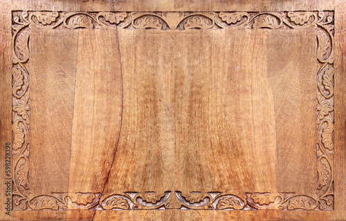 Horizontal background with wood carving floral ornament. Decorative carved border on wooden surface. Copy space for text