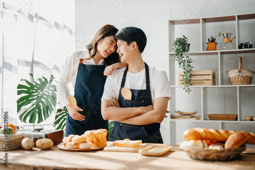 Happy asia young couple cooking together with vegetables with Bread and fruit in cozy on table kitchen table, love and valentine ..