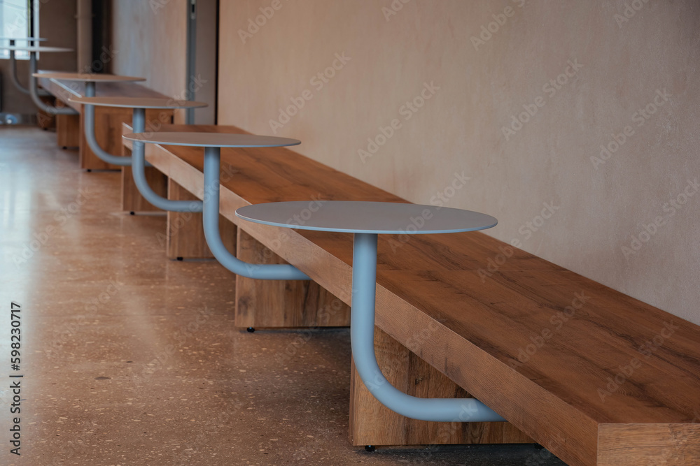 wooden bench with integrated round tables for rest in modern public place wooden bench with integrated round tables for rest in modern public place