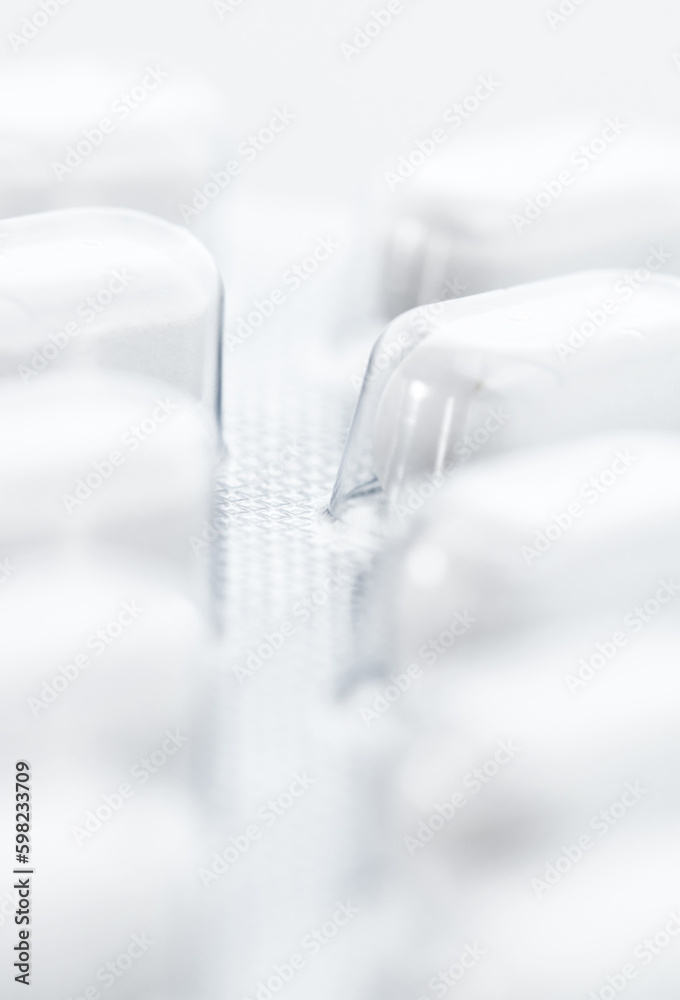 Closeup pills blister pack, selective focus and white background