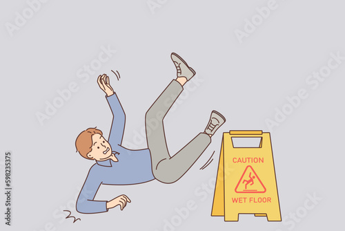 Man falls near warning sign with words caution wet floor due to negligence and inattention Generative AI
