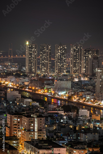 Ho Chi Minh city  Vietnam Apr 2023 Aerial night view of Ho Chi Minh city skyline district 7 look from a roof top of Gold view Apartment