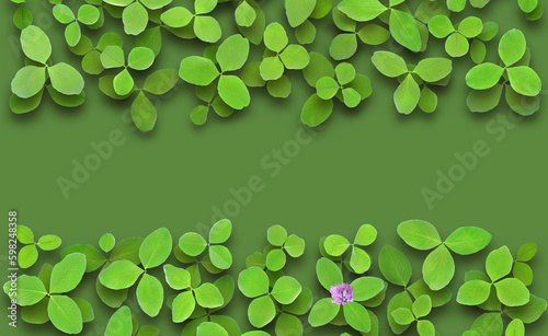Green foliage of clover border isolated on green background with copy space. Four leaf clover for good luck with a flower.