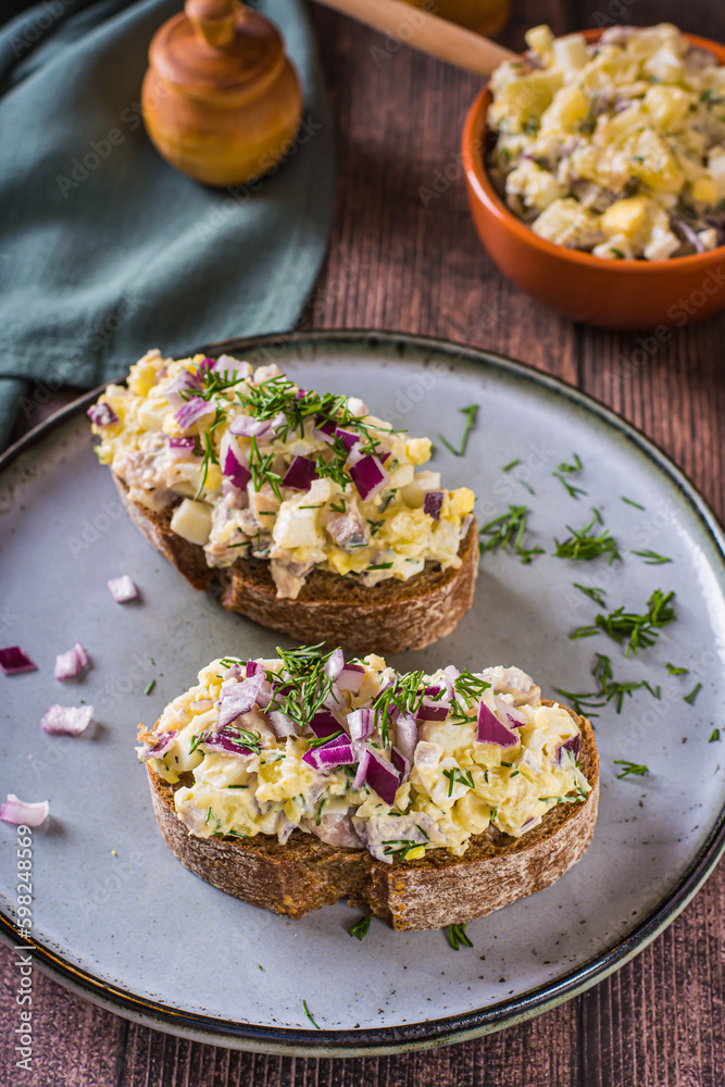 Bruschetta on rye bread with swedish salad on a plate on the table vertical view Bruschetta on rye bread with swedish salad on a plate on the table vertical view