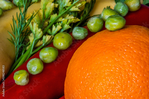 Orange, pepper, parsley and peas close-up