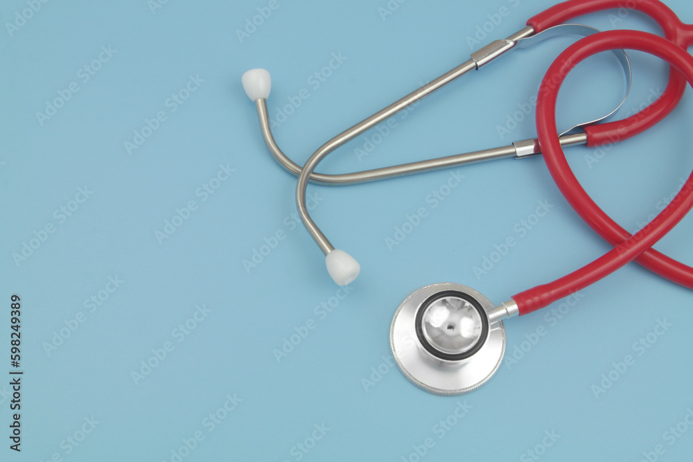 Red stethoscope on blue background with space for text. Red stethoscope on blue background with space for text.