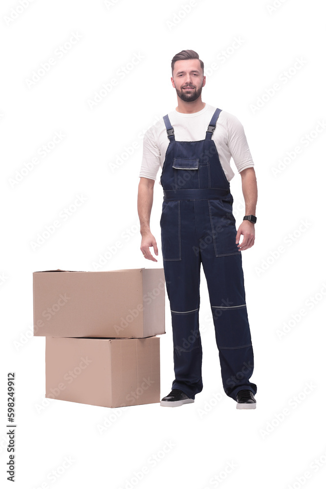 in full growth. smiling man standing near cardboard boxes