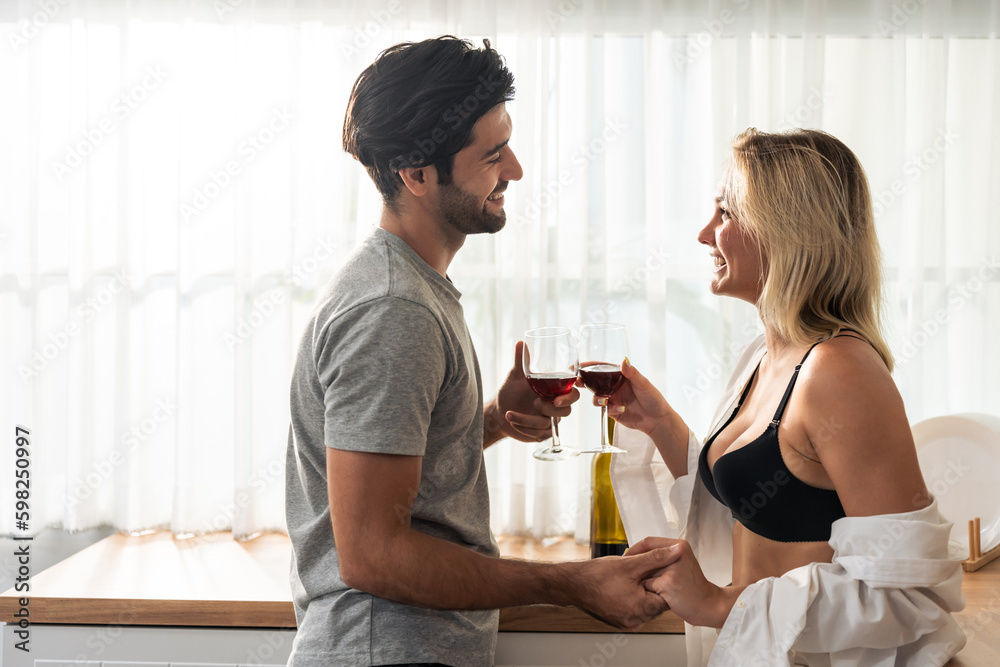 Caucasian young hot sexy couple clinking and drinking a glass of beer. Caucasian young hot sexy couple clinking and drinking a glass of beer.
